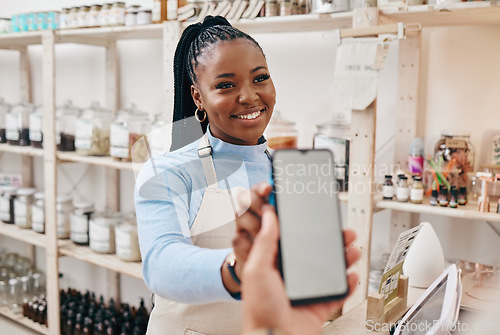 Image of Customer, black woman and payment with smartphone screen, finance and machine for transaction in a store. Business, shop assistant and employee with client, cellphone and technology with service