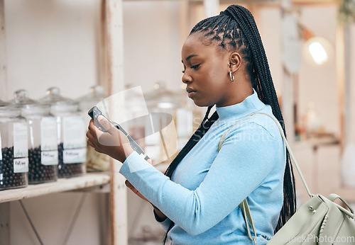 Image of Woman, shopping and reading ingredient bottle in local grocery store for healthy food, nutrition and wellness product sales. Thinking, African customer and salad dressing choice in retail supermarket