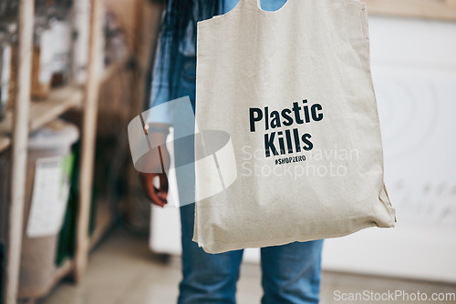 Image of Person in eco friendly grocery store, recycling shopping bag and commitment to climate change at sustainable small business. Zero waste, plastic kills logo and supermarket carbon footprint choice.