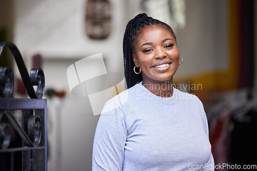 Image of Happy, black woman and portrait in clothes store, thrift shop and fashion workshop in owner pride. Smile, confident and professional designer in clothing small business, retail and donation industry