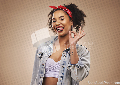 Image of Woman, ok sign and studio portrait with smile, tongue and funny face for good review by brown background. African girl, student or fashion model with hand for icon, vote or feedback with comic laugh