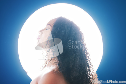 Image of Beauty, neon and face of woman with spotlight for wellness, cosmetics and skincare in studio. Circle, creative spa and profile of person for makeup, glamour and art deco aesthetic on blue background