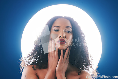 Image of Spotlight, skincare and portrait of woman with beauty for wellness, cosmetics and facial care in studio. Circle, creative lighting and person for makeup, face glamour and aesthetic on blue background