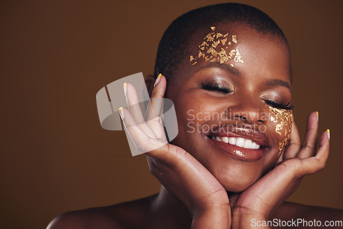 Image of Gold beauty, makeup and woman face closeup with a smile from luxury treatment and facial spa mask. Glitter art, golden dermatology and African person with creative and sparkle cosmetics in studio