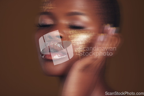 Image of Gold beauty, makeup and woman skincare with blur in studio with glitter cosmetics and sparkle art. Brown background, African female model and shine from paint and glow with golden luxury treatment