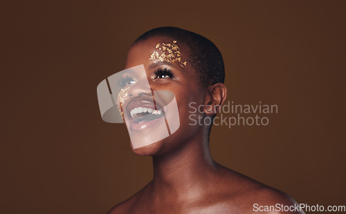 Image of Gold, makeup and woman laughing with beauty and luxury treatment and creative spa mask. Glitter, art dermatology and African female person happy from skincare and golden cosmetics in studio