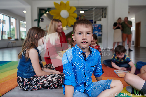 Image of Portrait photo of a smiling boy in a preschool institution having fun