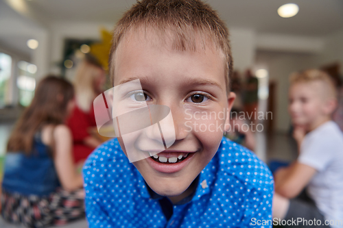 Image of Portrait photo of a smiling boy in a preschool institution having fun