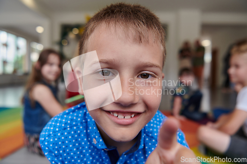 Image of Portrait photo of a smiling boy in a preschool institution having fun