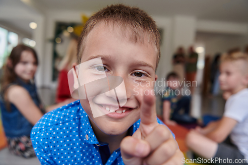 Image of Portrait photo of a smiling boy in a preschool institution having fun