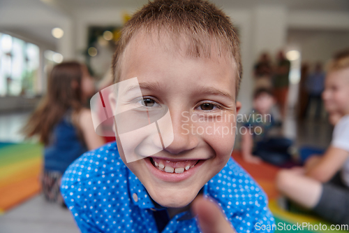 Image of Portrait photo of a smiling boy in a preschool institution having fun