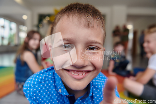 Image of Portrait photo of a smiling boy in a preschool institution having fun