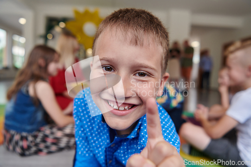 Image of Portrait photo of a smiling boy in a preschool institution having fun