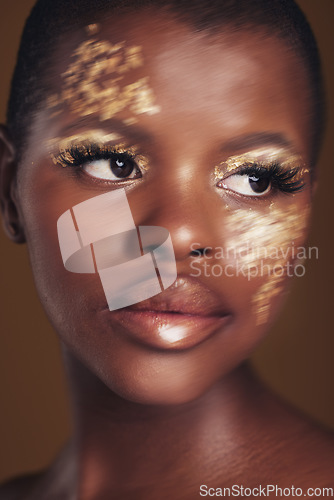 Image of Gold, art and African woman with makeup for beauty aesthetics isolated in a studio brown background thinking. Creative, luxury and face of person with cosmetic glamour or design for skincare