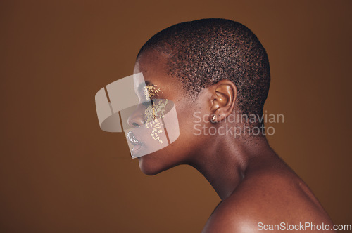 Image of Art, profile of black woman with gold makeup and blurred background, glitter paint and cosmetics. Shine, glow and African model in studio for beauty, fashion and aesthetic freedom in luxury skincare.