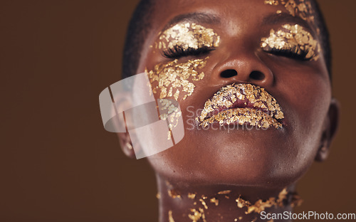 Image of Gold, art and face of African woman with makeup for beauty aesthetics isolated in a studio brown background eyes closed. Creative, luxury and person with cosmetic glamour or design for skincare