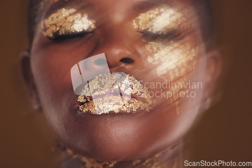 Image of Gold beauty, face and woman closeup with blur in studio with glitter cosmetics and sparkle art. Brown background, African female model and shine from makeup and skin glow with golden luxury treatment