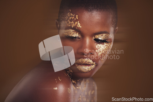 Image of Gold beauty, luxury makeup and black woman with blur in studio with glitter cosmetics and sparkle art. Brown background, African female model and shine from paint and skin glow with golden treatment