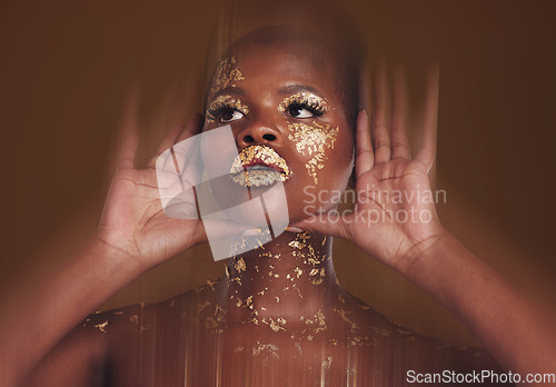 Image of Gold beauty, makeup and black woman face with hands and blur in studio with glitter cosmetics and sparkle art. Brown background, African female model and shine from paint glow with luxury treatment