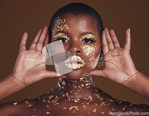 Image of Cosmetics, portrait and black woman with gold makeup on brown background with glitter paint. Shine, glow and African model in studio for beauty, fashion art and aesthetic freedom in luxury skincare.