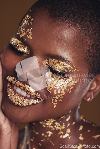 Image of Black woman, face and gold cosmetics closeup with luxury dermatology and skincare mask with glitter. Sparkle, smile and beauty with rich and shine of makeup and model in a studio with facial art