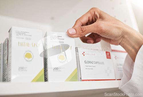 Image of Person, pharmacist and hands with box on shelf for inventory inspection or checking stock at pharmacy. Closeup of medical or healthcare worker with pills, medication or pharmaceutical at drugstore