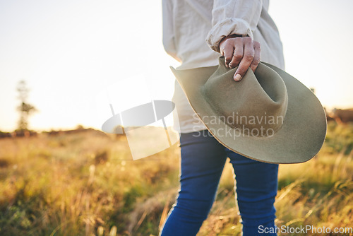 Image of Farm, agriculture and woman with hat in field on holiday, vacation and travel in countryside. Walk, morning and hands of person with freedom in nature for sustainable farming, growth and environment