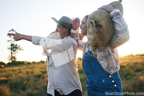 Image of Farm harvest, women point and countryside with a smile from working on a grass field with grain bag. Sustainability, eco friendly and agriculture outdoor at sunset in nature with farmer growth view