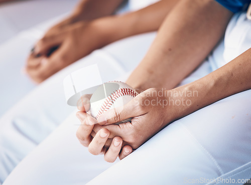 Image of Hands, sports and baseball with a player in a dugout, waiting during a game of competition closeup. Ball, ready and uniform with an athlete holding equipment for a match in a stadium or venue