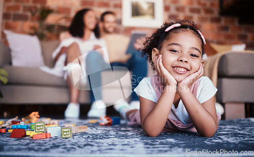 Image of Child, toys and playing portrait in home with development and building block in living room. Family, youth smile and happy young girl with parents in a house together with care and kids learning