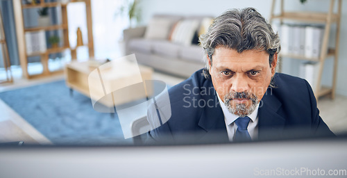 Image of Mature businessman, reading and computer in home, apartment or corporate employee with remote work in lounge. Distance, working and manager with project, report or review on pc in house office