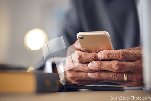 Image of Closeup hand, typing and a person with a phone for communication, email check or contact. Desk, work and a man with a mobile in an office for an online app, connection and reading a notification