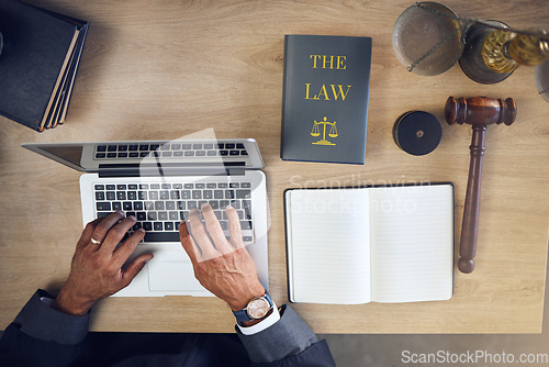 Image of Above, hands and laptop typing for law, planning justice or working at a desk in office. Attorney, research and a lawyer or legal employee with a computer at a table for connection and communication