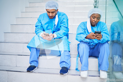 Image of Doctor team, stairs and smartphone in hospital for telehealth, healthcare or online wellness. Phone, surgeon and people on steps on internet, reading email and medical professional research in clinic