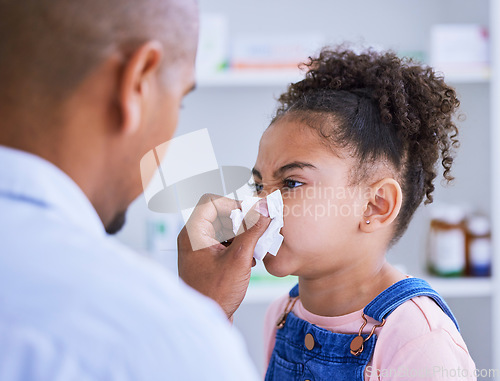 Image of Blowing nose, child and doctor with sick, disease and virus in a hospital or clinic. Paediatrician, young girl and tissue for allergies or flu with toilet paper for medical healthcare and support