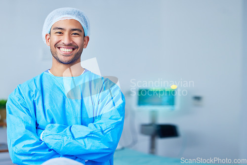 Image of Portrait, surgeon and Asian man with arms crossed in hospital, healthcare and wellness. Face, happy doctor and medical professional, expert nurse and confident surgery employee in scrubs in Cambodia