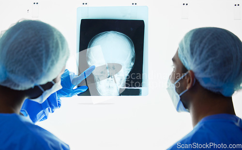 Image of Head xray, doctors and healthcare team planning test results, charts and advice for medical analysis. Radiology, neurology and surgeons check skull x ray, anatomy and review mri for hospital surgery