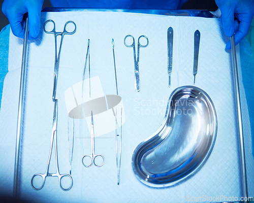 Image of Surgery, tools and medical table in hospital, operation room and equipment with scalpel knife, scissors and metal bowl. Surgeon, hands and above doctor ready with medicine or tool for procedure