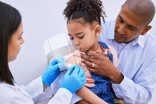 Image of Doctor, father and child with plaster for vaccine, flu shot or medicine injection in clinic or hospital. Dad, girl with bandage and pediatrician in office for vaccination, consultation and healthcare