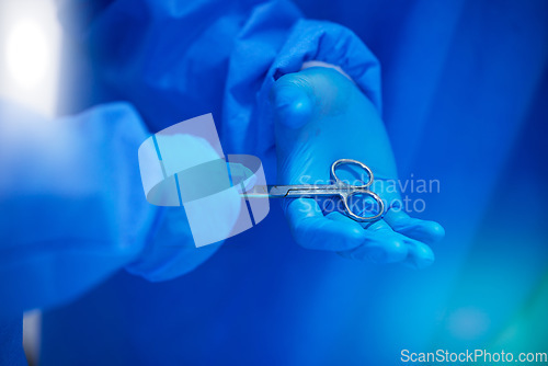 Image of Closeup, surgery and hands with a scissor for healthcare, hospital work and help. Support, team and doctors, surgeons or medical employees with gloves for cardiology or professional cooperation