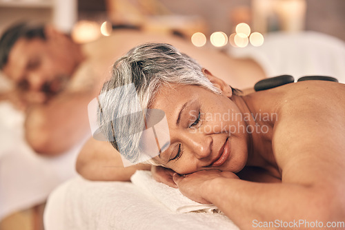 Image of Hot stone, massage and zen with old couple in spa for vacation, luxury and beauty salon. Peace, wellness and holiday with senior woman and man in hotel villa for retirement, treatment and body care