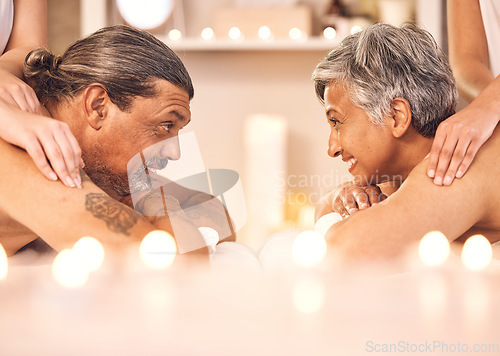 Image of Mature couple, romantic massage at spa in candle light and wellness, relax and smile together. Holistic health therapy, zen and calm man with woman in profile on table in luxury salon in retirement.