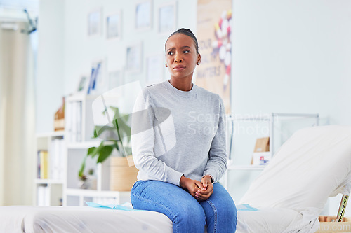 Image of Black woman, sick and patient waiting in stress on hospital bed for doctor in checkup, appointment or consultation. African female person with flu, fever or mental health in illness or clinic advice