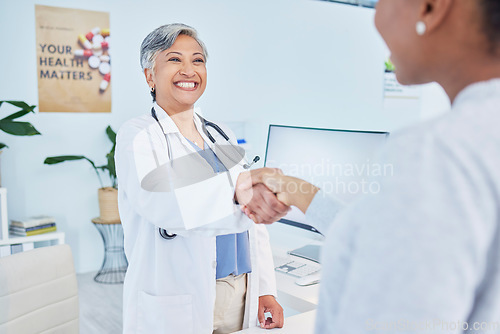 Image of Happy doctor, handshake and meeting patient in healthcare, visit or appointment at the hospital. Mature female person or medical professional shaking hands with customer in greeting or consultation