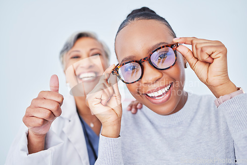 Image of Eye care, glasses and patient with doctor, women at clinic, optometry and frame choice with help and thumbs up. Wellness, health and prescription lens, support from optometrist, trust and eyewear