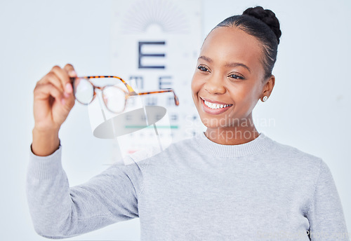 Image of Eye care, glasses choice and patient, black woman is happy at clinic, optometry and frame with help and healthcare. Wellness, health and prescription lens, eyewear and decision with vision and smile