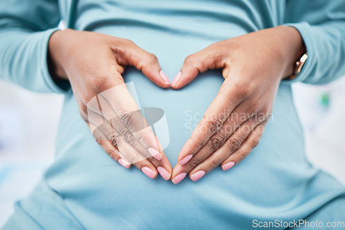 Image of Heart, woman hand and pregnancy love in a hospital with mama, stomach and baby care. Wellness, abdomen and pregnant female person with emoji and happy mom gesture of a check for health of a mother