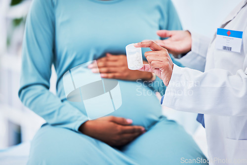 Image of Doctor, pregnant patient and hands, pills in container and woman at hospital with gynecology. Supplements, healthcare and pregnancy, medical advice and fertility, help and trust from gynecologist