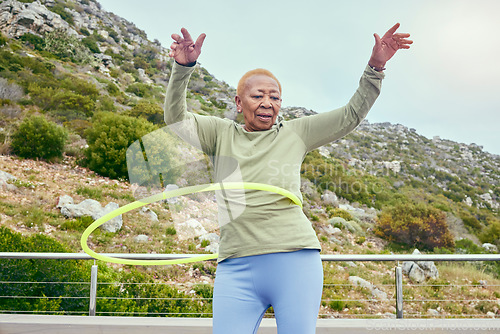 Image of Senior fun, game and black woman with a hula hoop for sports, exercise or cardio in nature. Happy, elderly and an African person training with a toy for a workout, recreation or hobby on the weekend