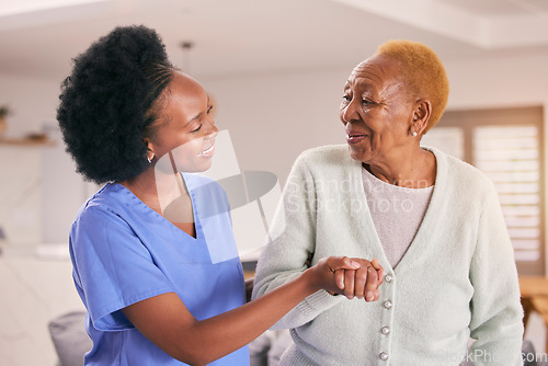 Image of Help, nurse and holding hands of senior black woman, care and smile in house together. Caregiver, support and elderly patient with medical professional, kindness and happy in empathy for healthcare